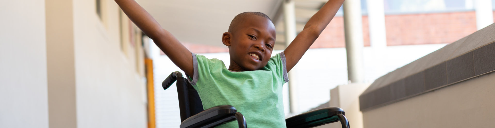 a happy child in a wheelchair