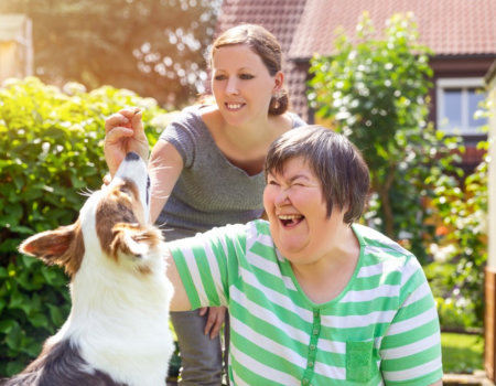 women playing with a dog